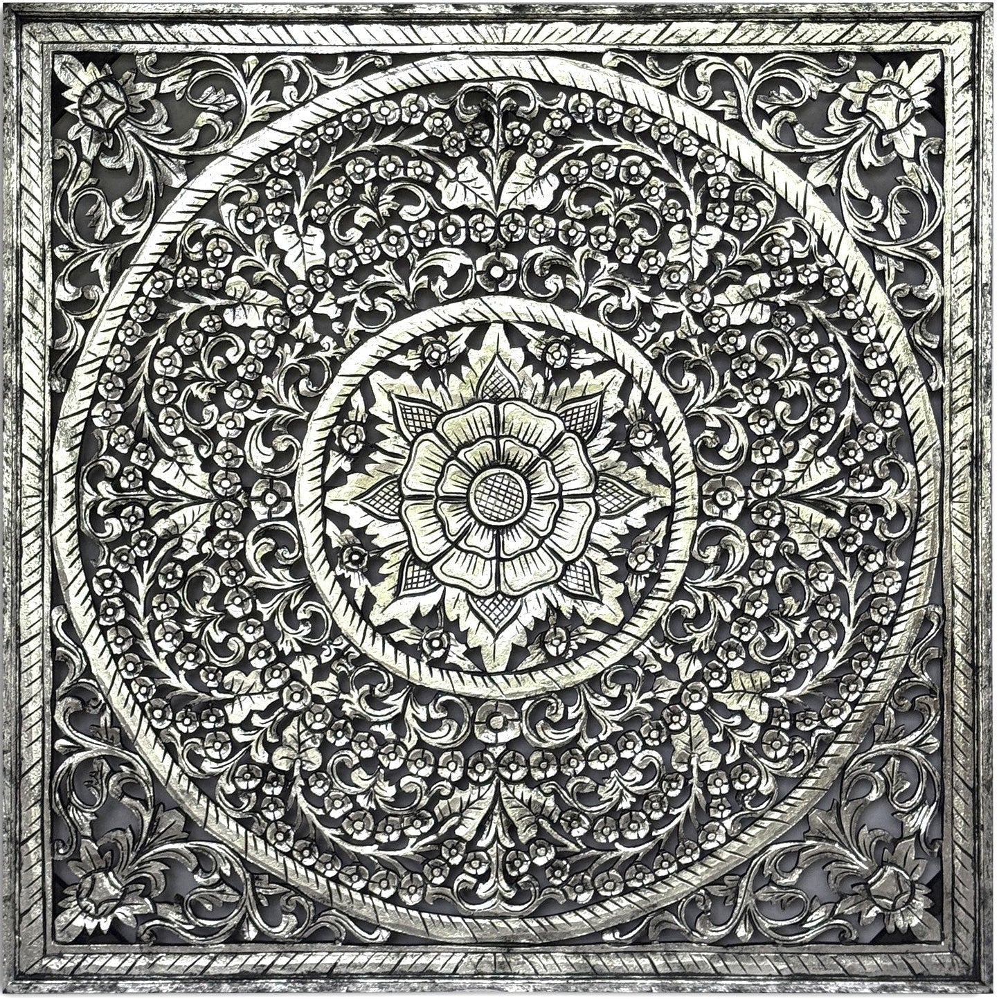 A square decorative wall plaque featuring an intricate, raised circular mandala design with floral and scrollwork patterns in a metallic silver finish, shown against a plain white background.