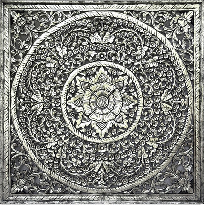 A square decorative wall plaque featuring an intricate, raised circular mandala design with floral and scrollwork patterns in a metallic silver finish, shown against a plain white background.