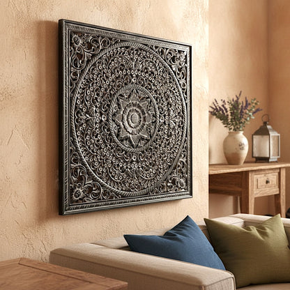 Decorative wall art piece on a beige wall above a sofa with pillows.